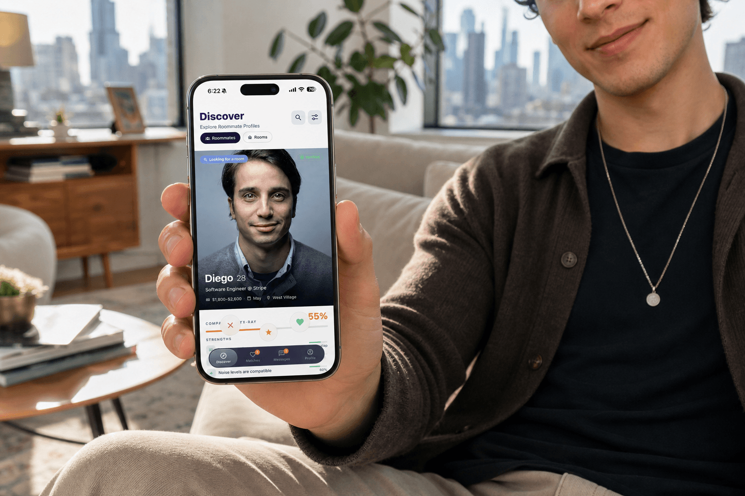 A person holding an iPhone showing the Jilo Discover screen